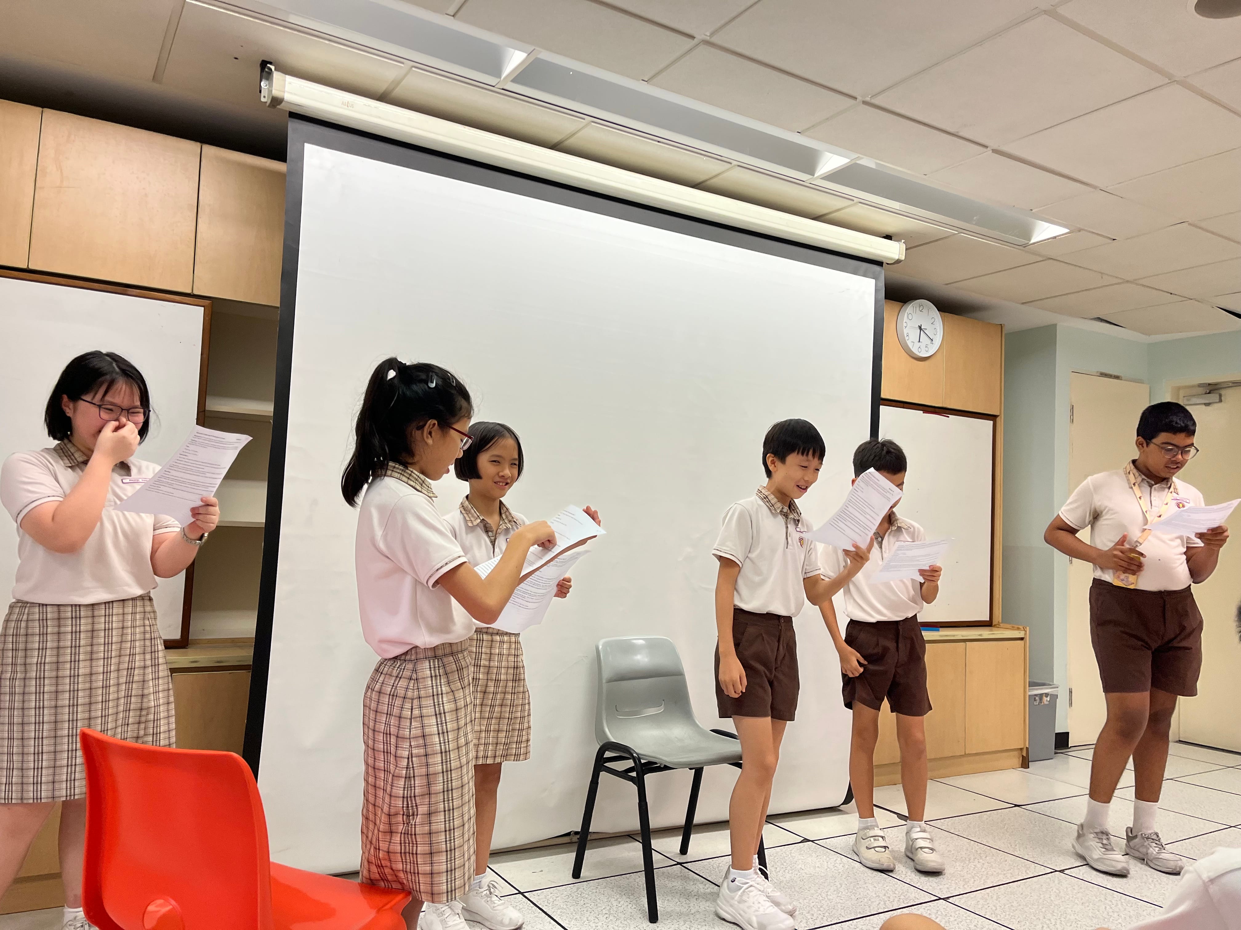 Students performing a skit to showcase their solution for an instant challenge
